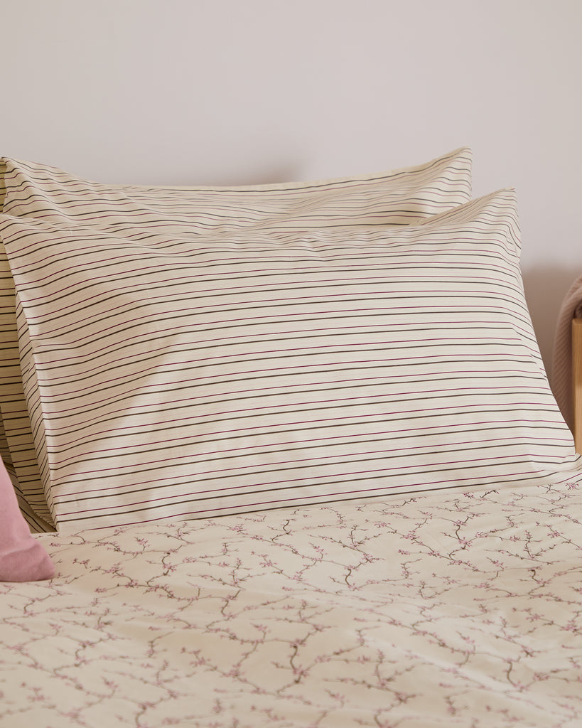 Striped pillow on a bed with a light background