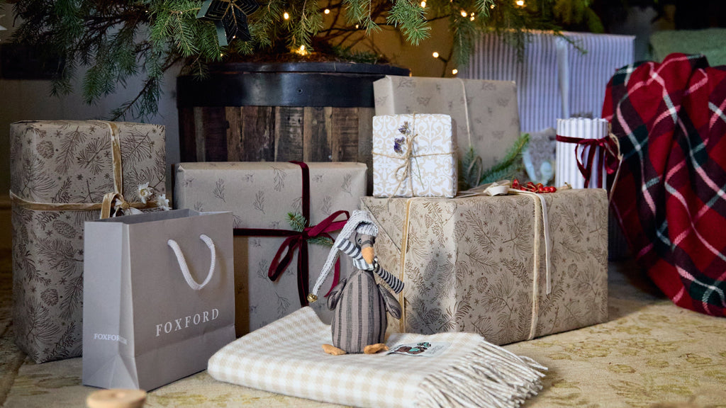 Christmas presents including a FOXFORD throw under a Christmas Tree